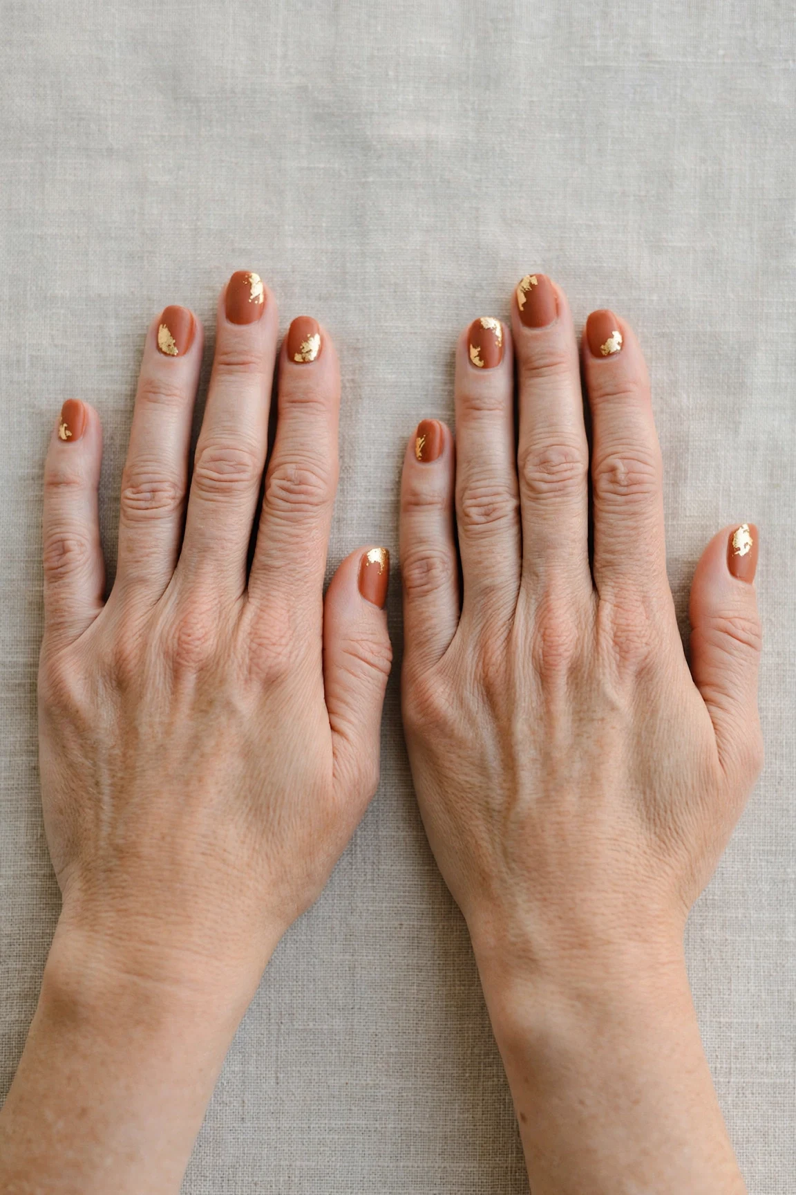 Cinnamon Terracotta Short Nails with a soft matte finish and gold foil accents