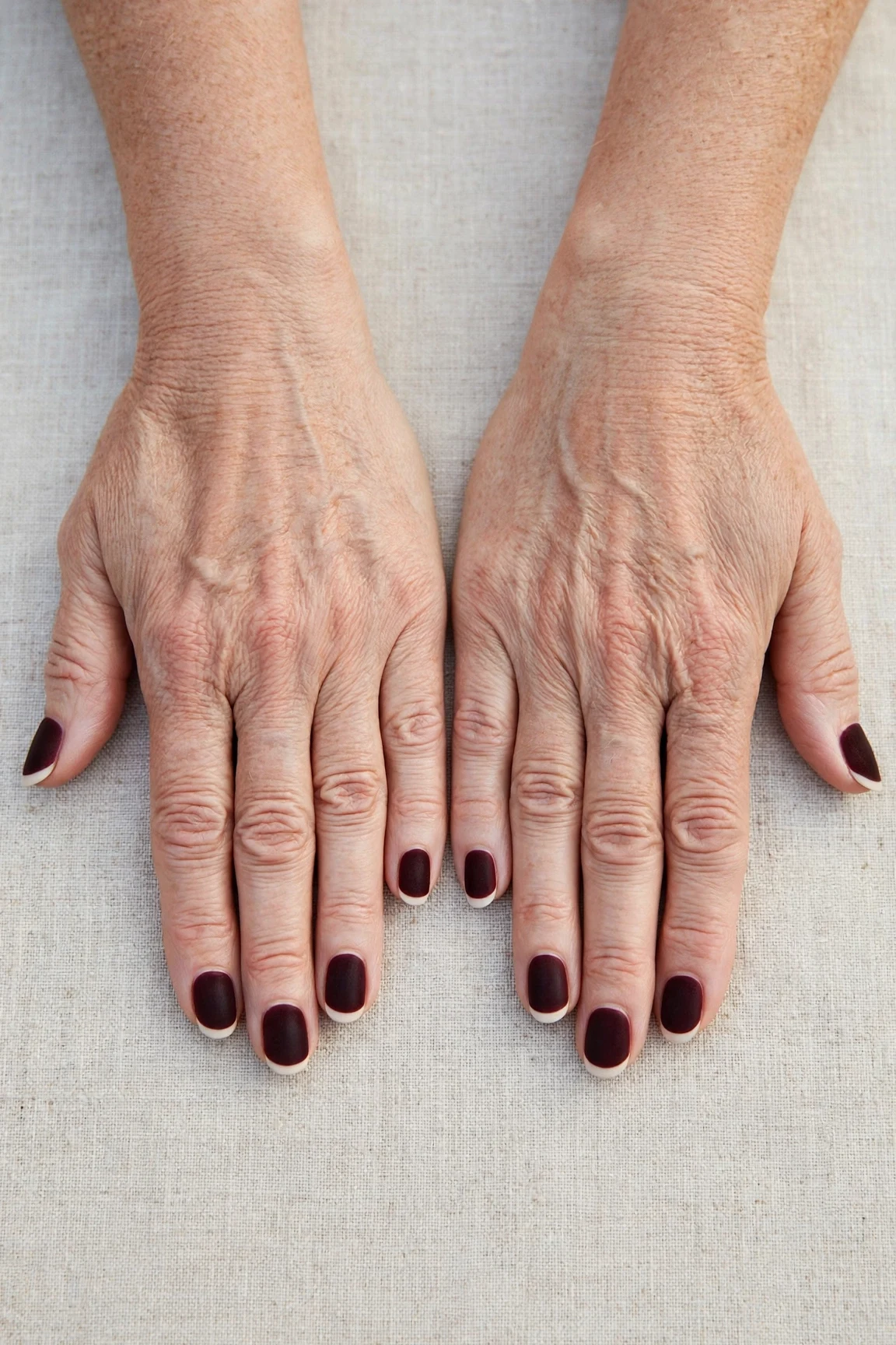 Dark Cherry Velvet French Tip Nails with a soft matte finish and classic cream French tips