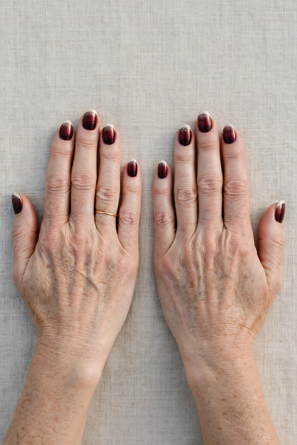 Dark Cherry Velvet French Tip Nails with a glitter gradient finish and classic cream French tips
