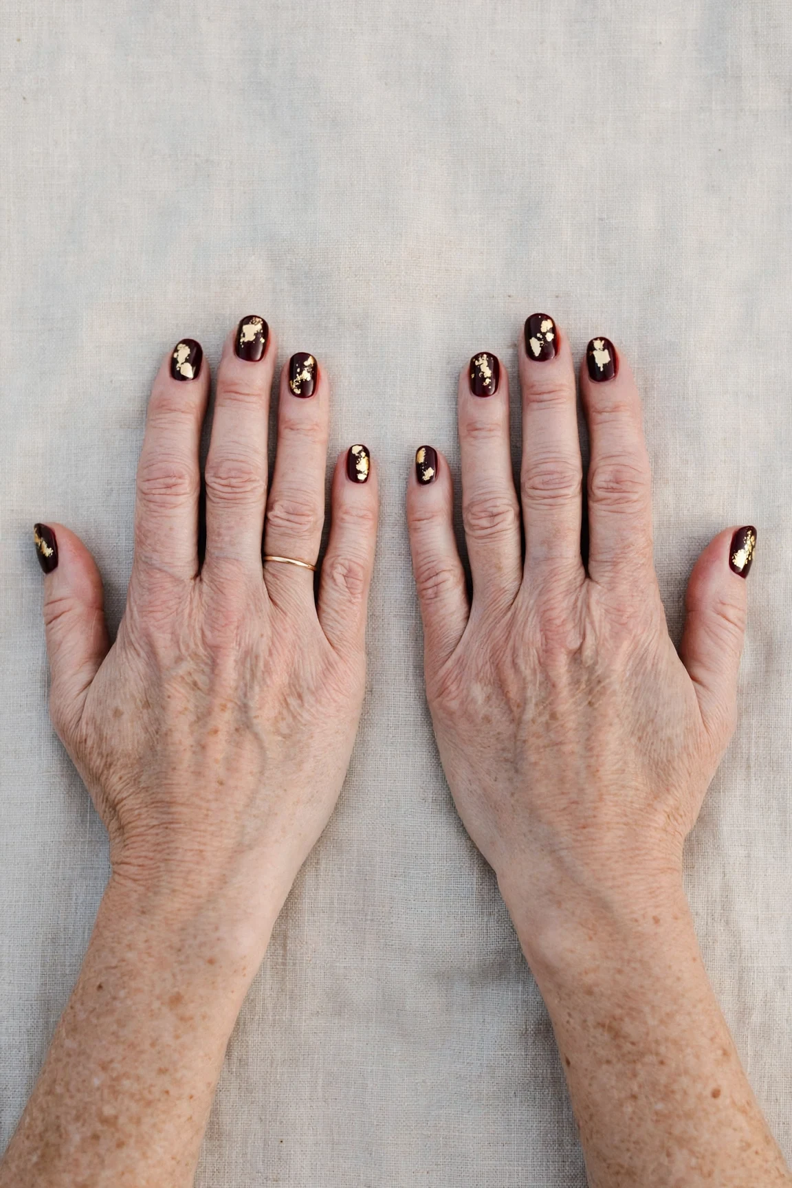 Short Oval Dark Cherry Velvet Manicure Ideas with a high-gloss finish and gold foil accents