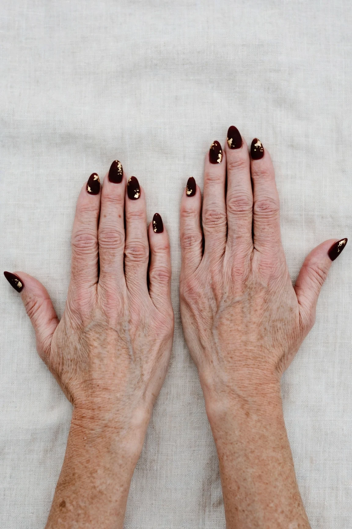 Almond Dark Cherry Velvet Manicure Ideas with a soft matte finish and gold foil accents