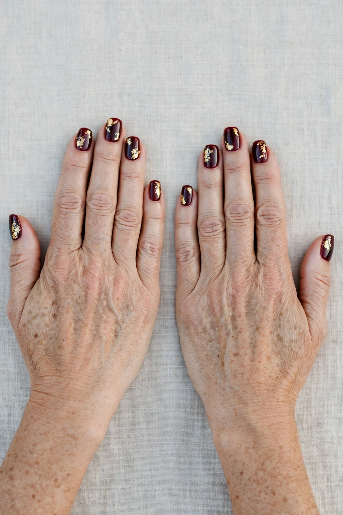 Squoval Dark Cherry Velvet Manicure Ideas with a sheer jelly finish and gold foil accents
