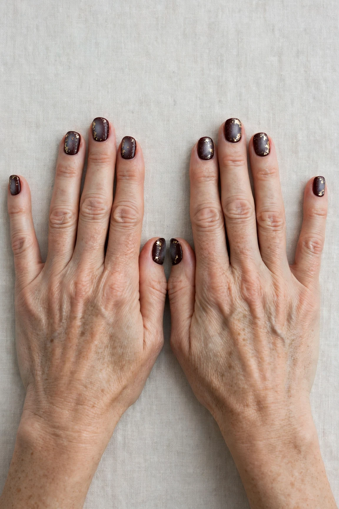 Short Round Dark Cherry Velvet Manicure Ideas with a frosted shimmer finish and gold foil accents