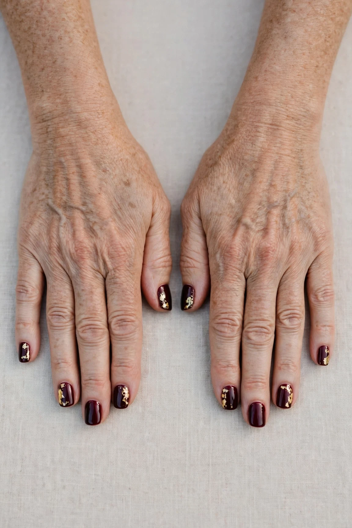 Short Square Dark Cherry Velvet Nails with a glassy gel finish and gold foil accents