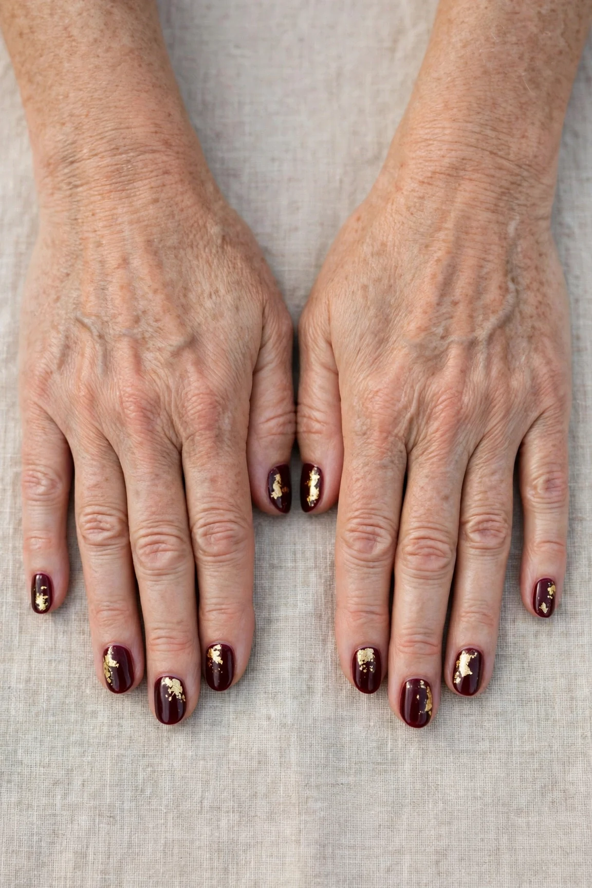 Dark Cherry Velvet Short Nails with a high-gloss finish and gold foil accents