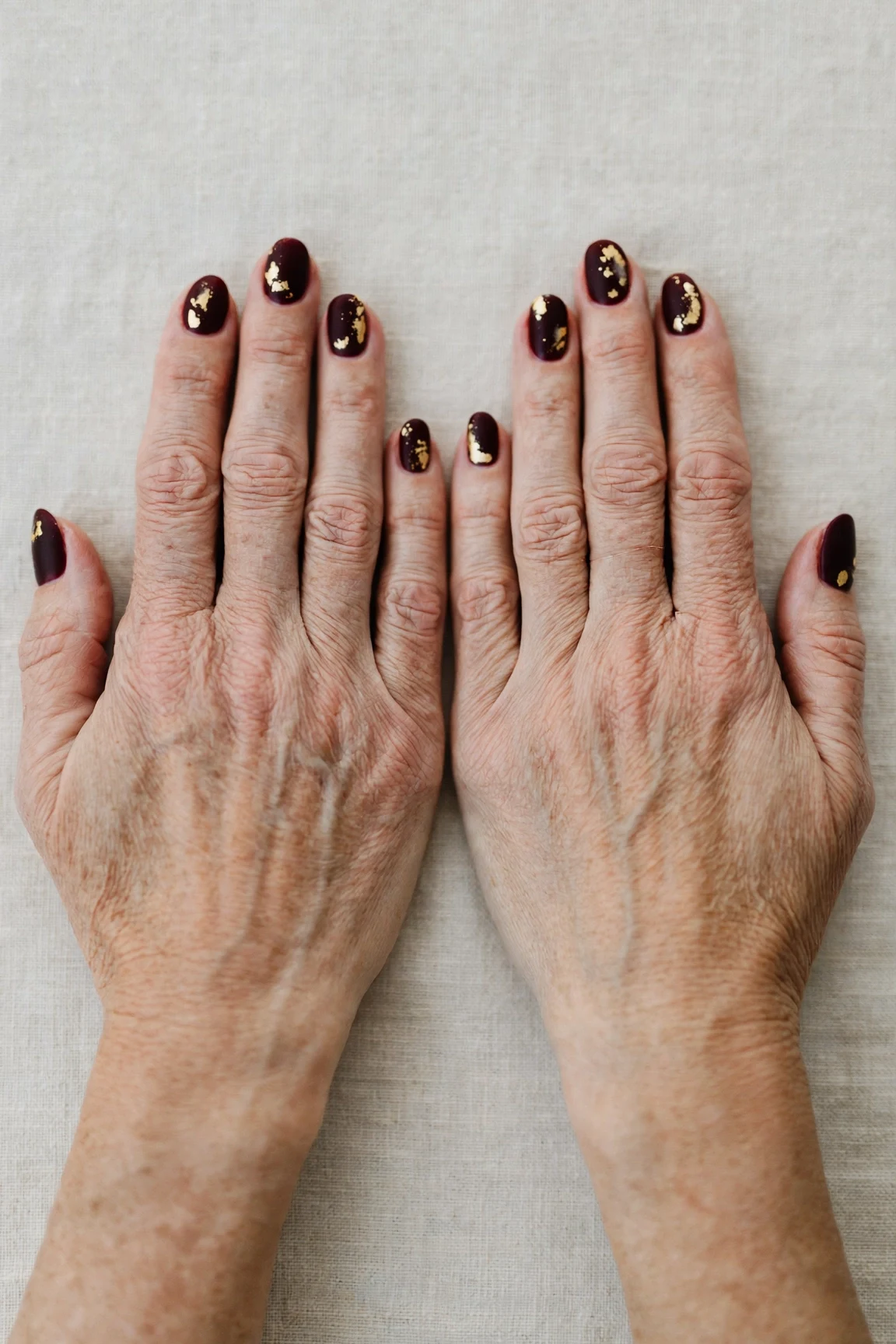 Dark Cherry Velvet Short Nails with a soft matte finish and gold foil accents