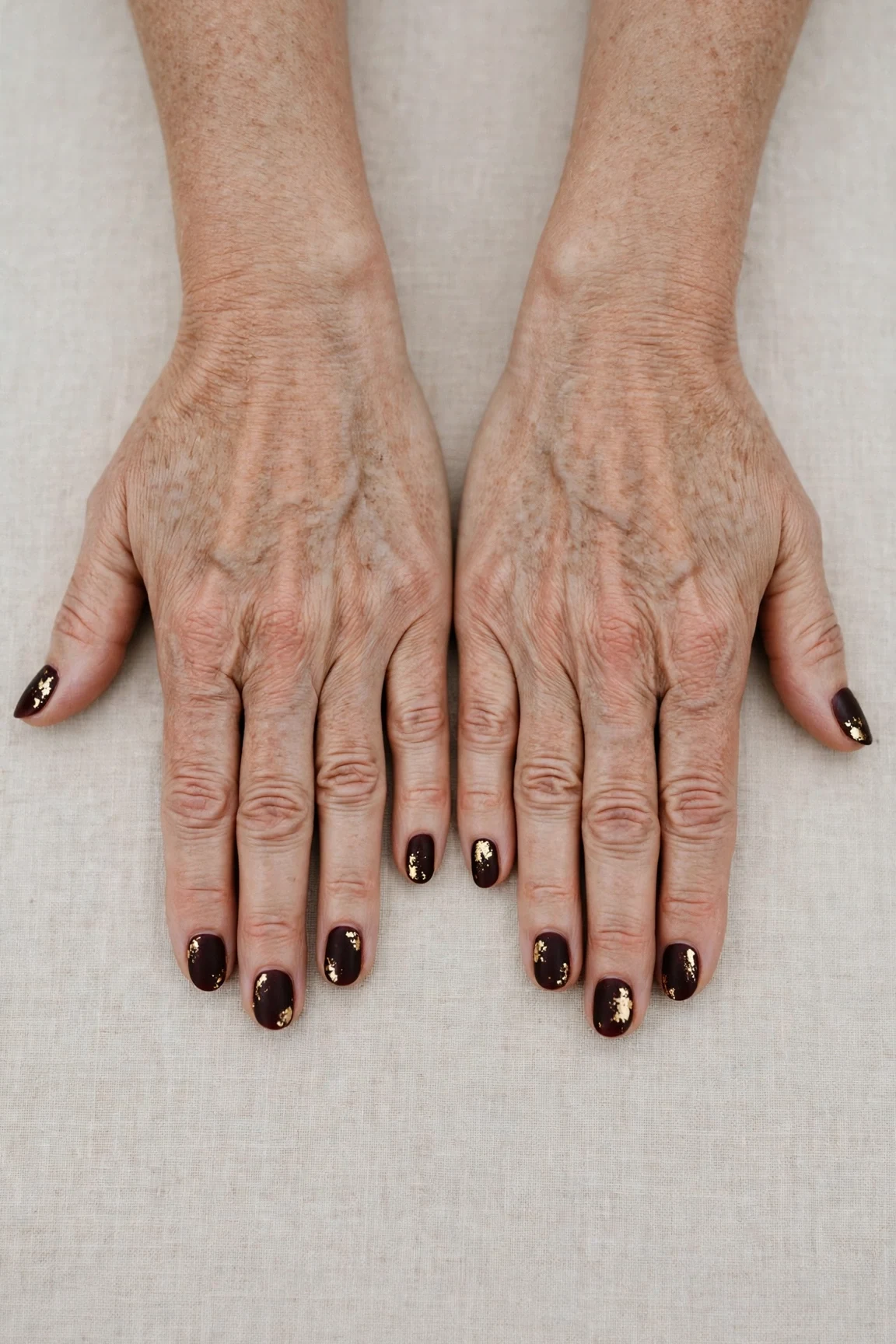 Dark Cherry Velvet Short Nails with a velvet matte finish and gold foil accents