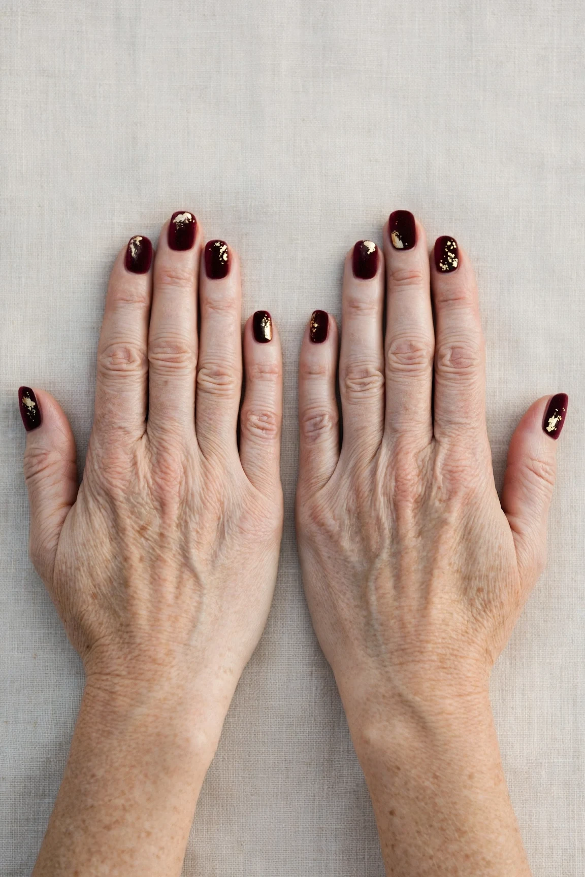 Dark Cherry Velvet Short Nails with a satin finish and gold foil accents