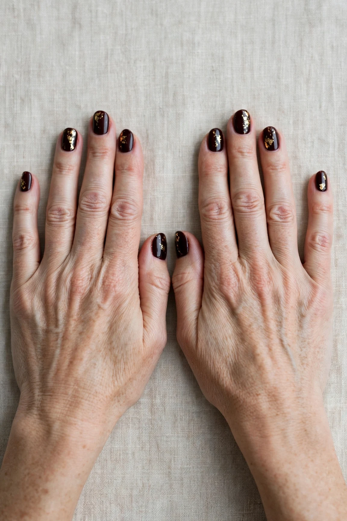 Dark Cherry Velvet Short Nails with a deep glossy shine and gold foil accents
