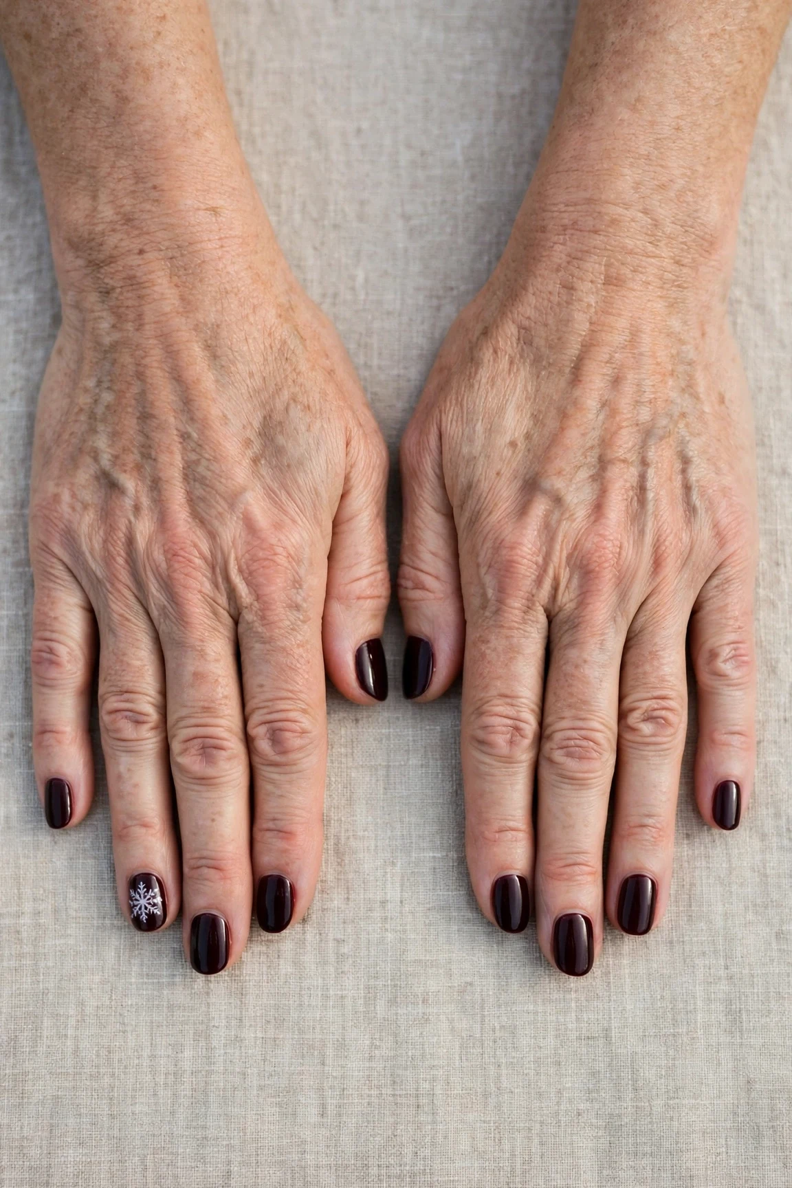 Dark Cherry Velvet Short Nails with a high-gloss finish and a delicate snowflake on the ring finger