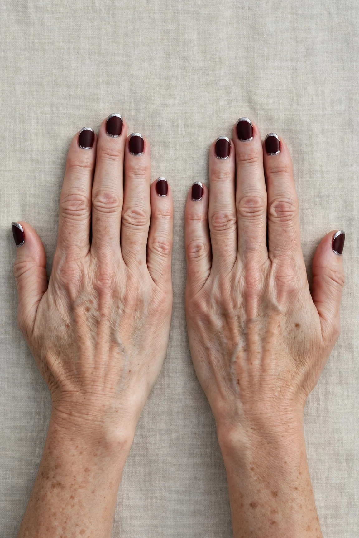 Dark Cherry Velvet Short Nails with a soft matte finish and silver shimmer tips