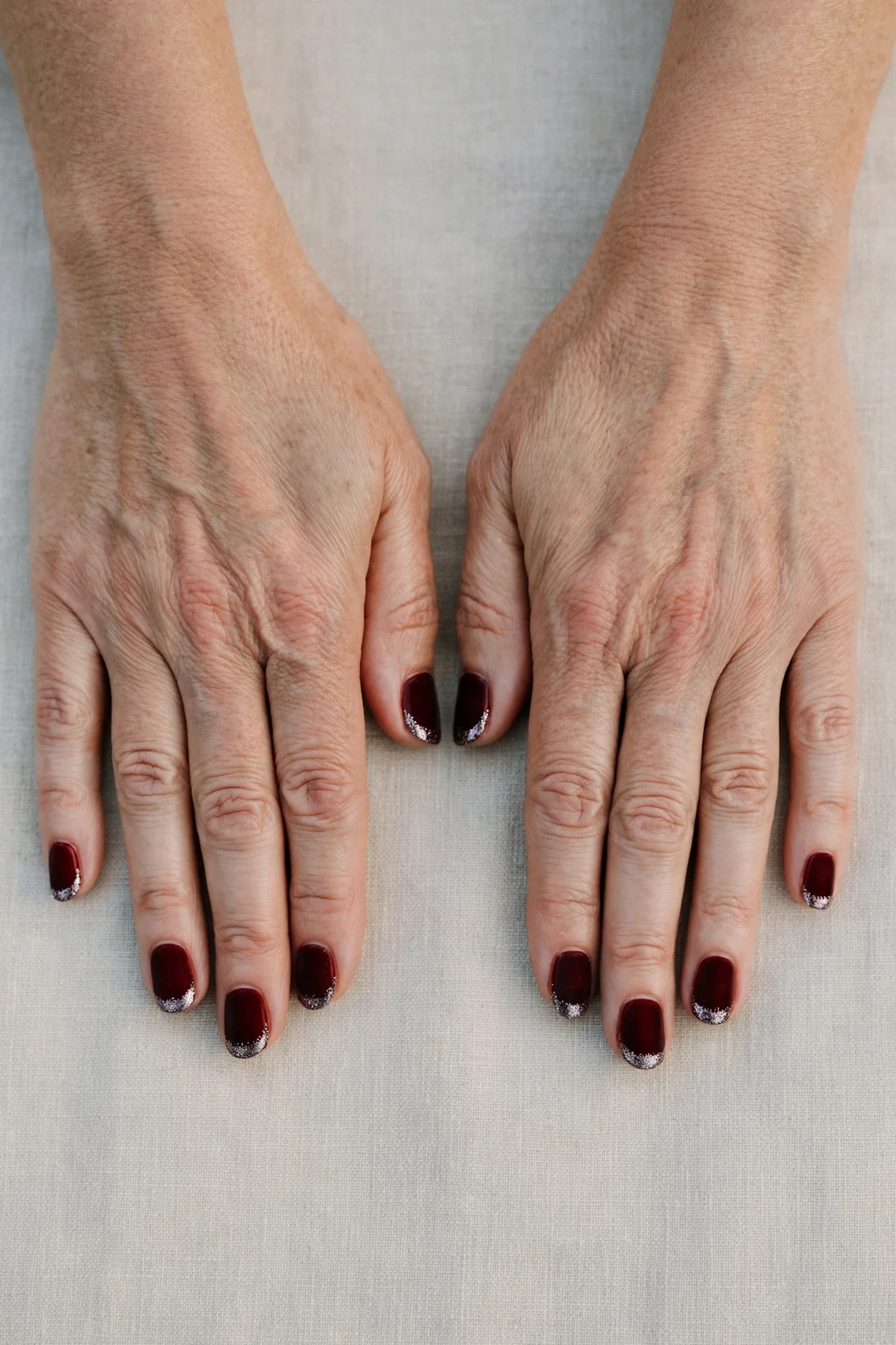 Dark Cherry Velvet Short Nails with a velvet matte finish and silver shimmer tips