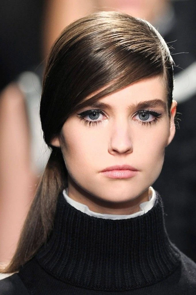 Sleek Low Ponytail with a Deep Side Sweep and Straight Lengths