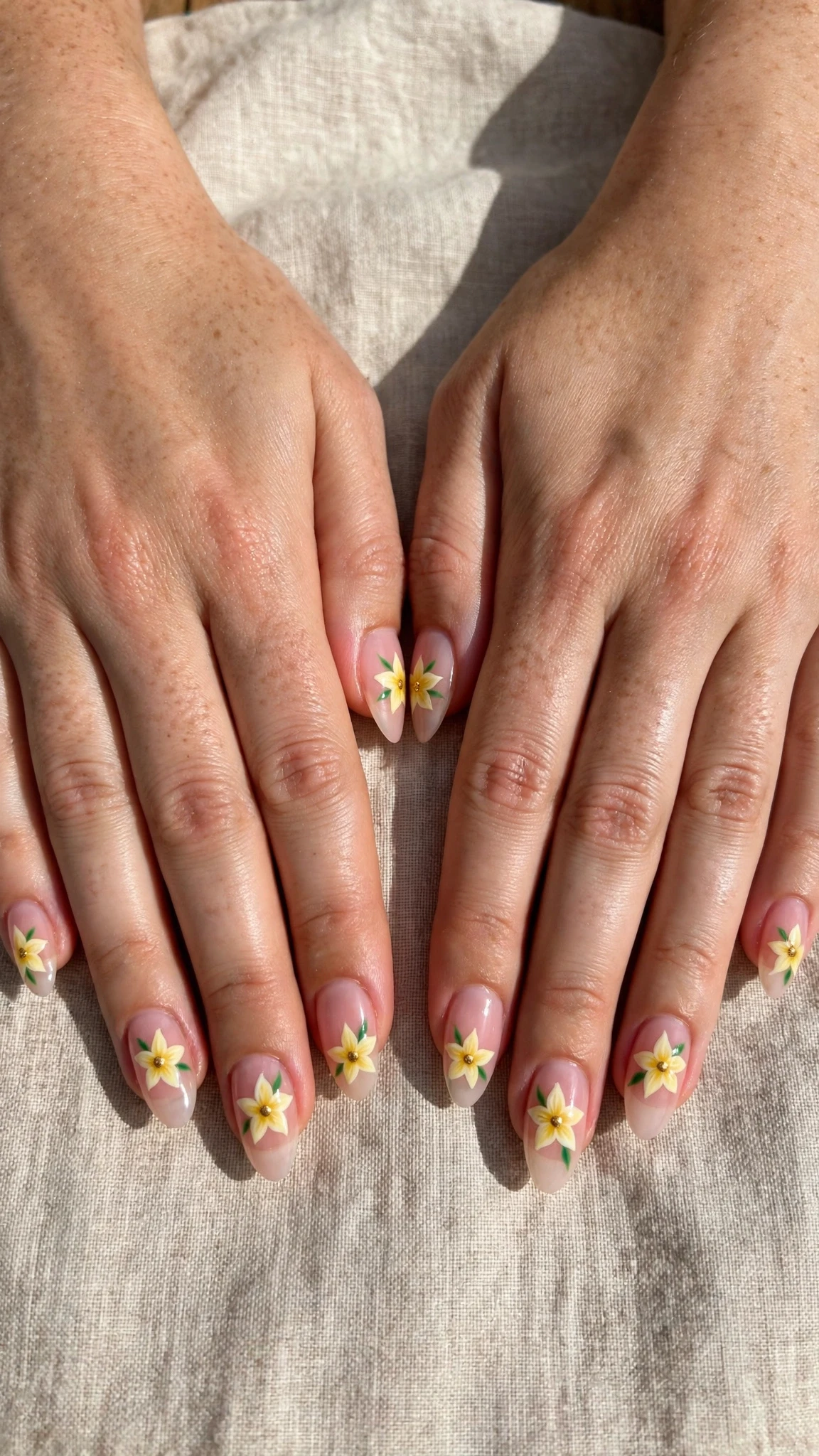 Daffodil with a gold dot centre on sheer pink almond nails