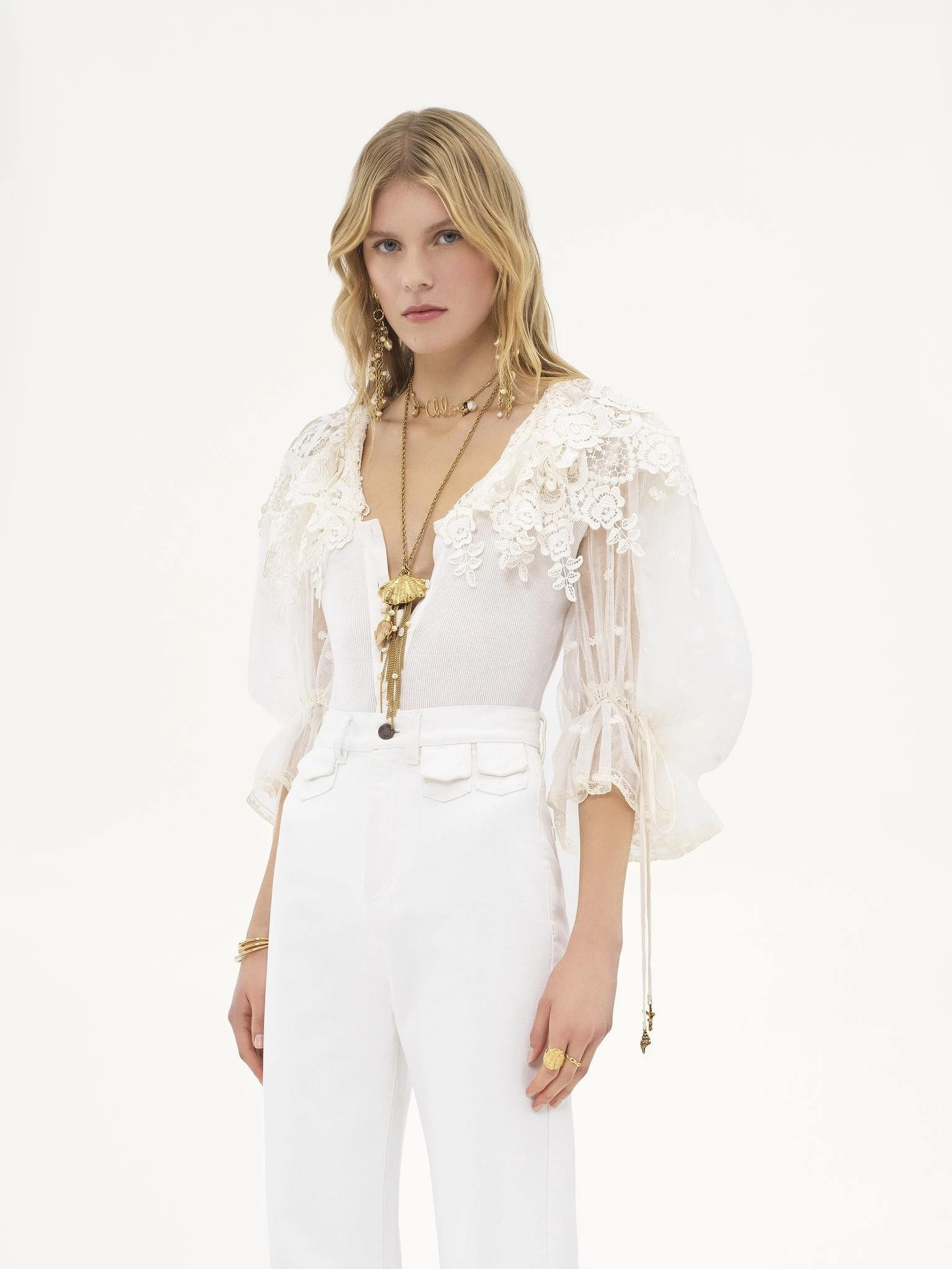 White Lace Peplum Blouse and Trousers with a gold pendant necklace