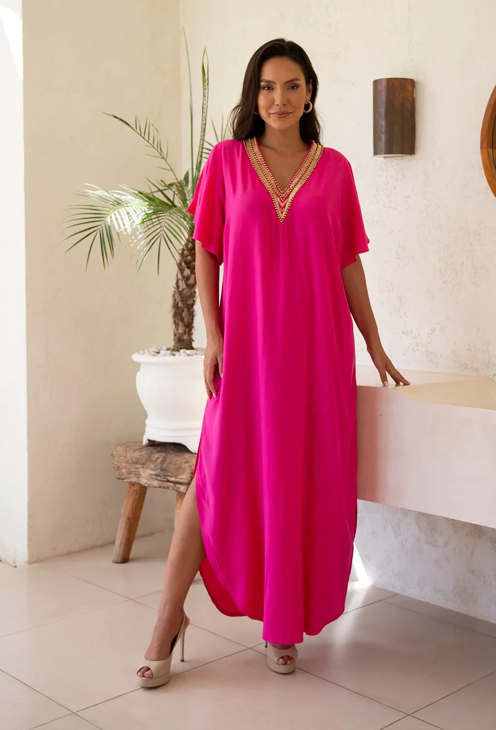 Hot Pink Maxi Dress with a gold pendant necklace