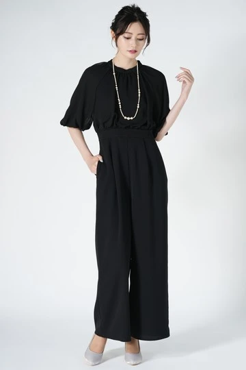 Black Ruffle Blouse and Wide-Leg Trousers with a pearl bracelet