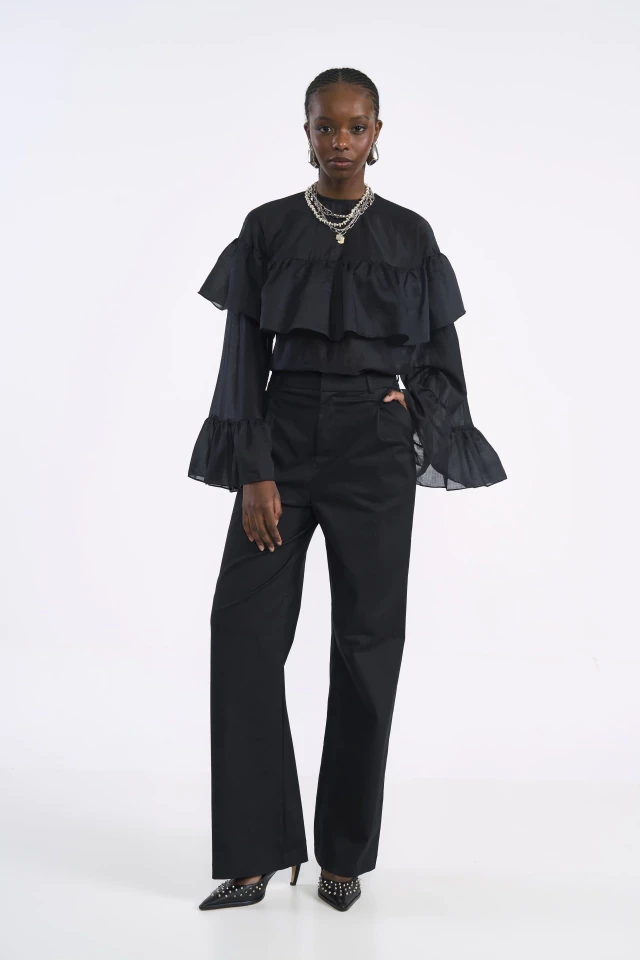 Black Ruffle Blouse and Wide-Leg Trousers with silver drop earrings