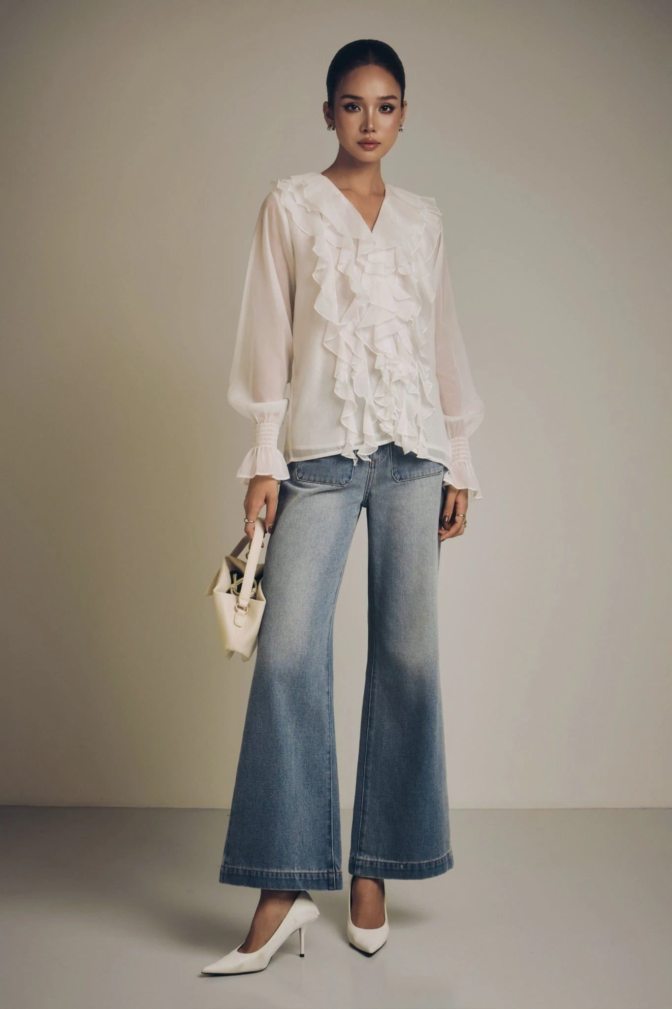 White Ruffle Blouse and Jeans with a structured tote