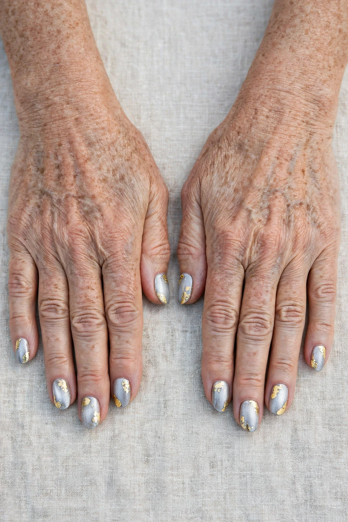 Oval Icy Silver Frosted Chrome Nails with a satin finish and gold foil accents