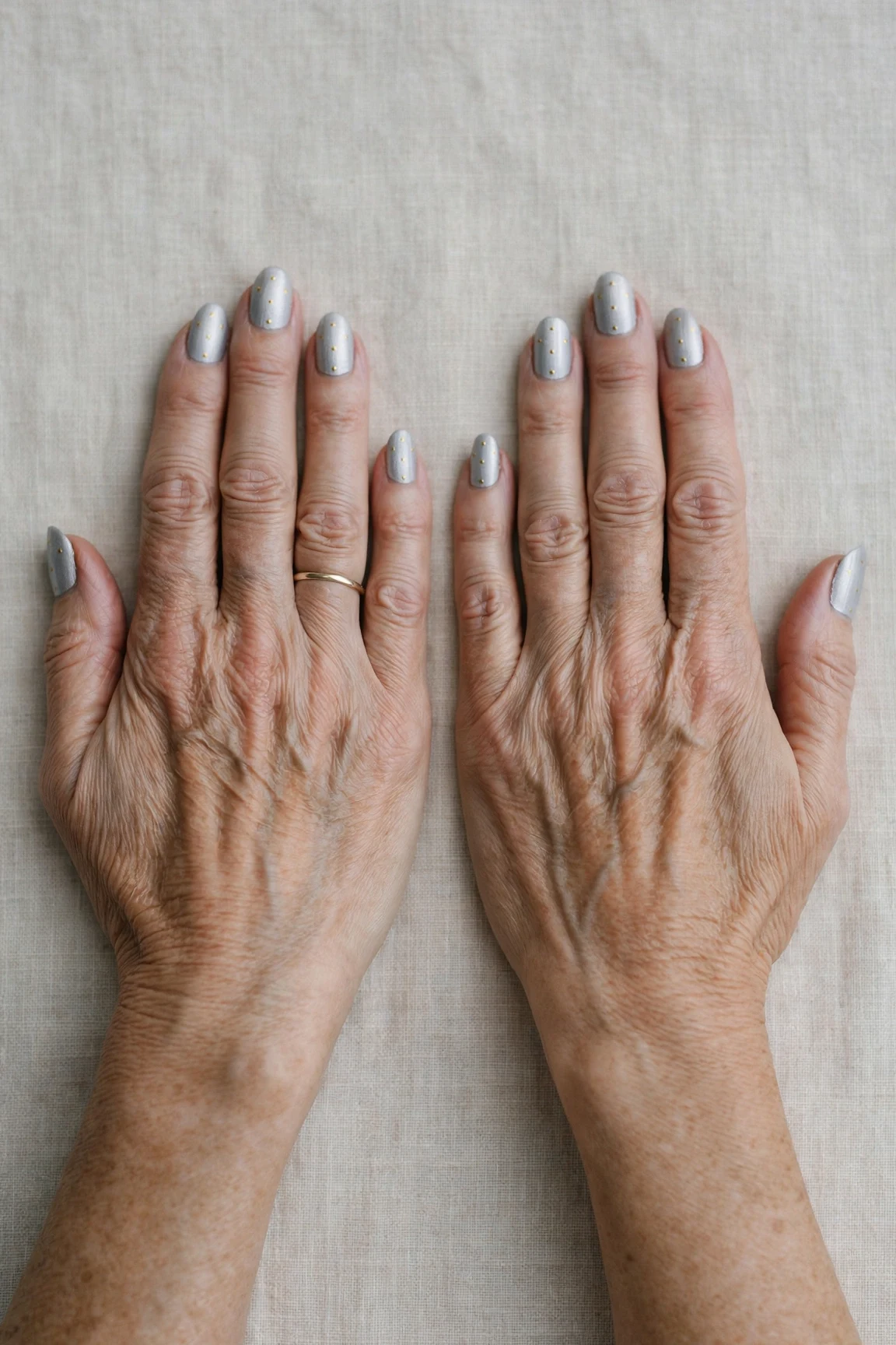 Almond Icy Silver Frosted Chrome Nails with a soft matte finish and tiny gold dots