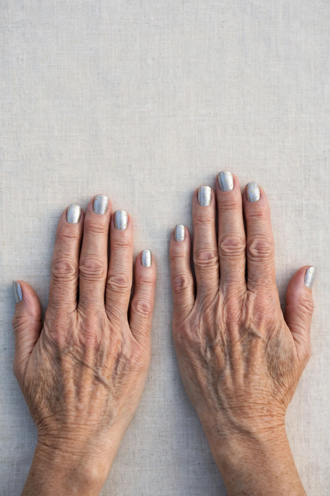 Short Square Icy Silver Frosted Chrome Nails with a chrome shine and tiny gold dots