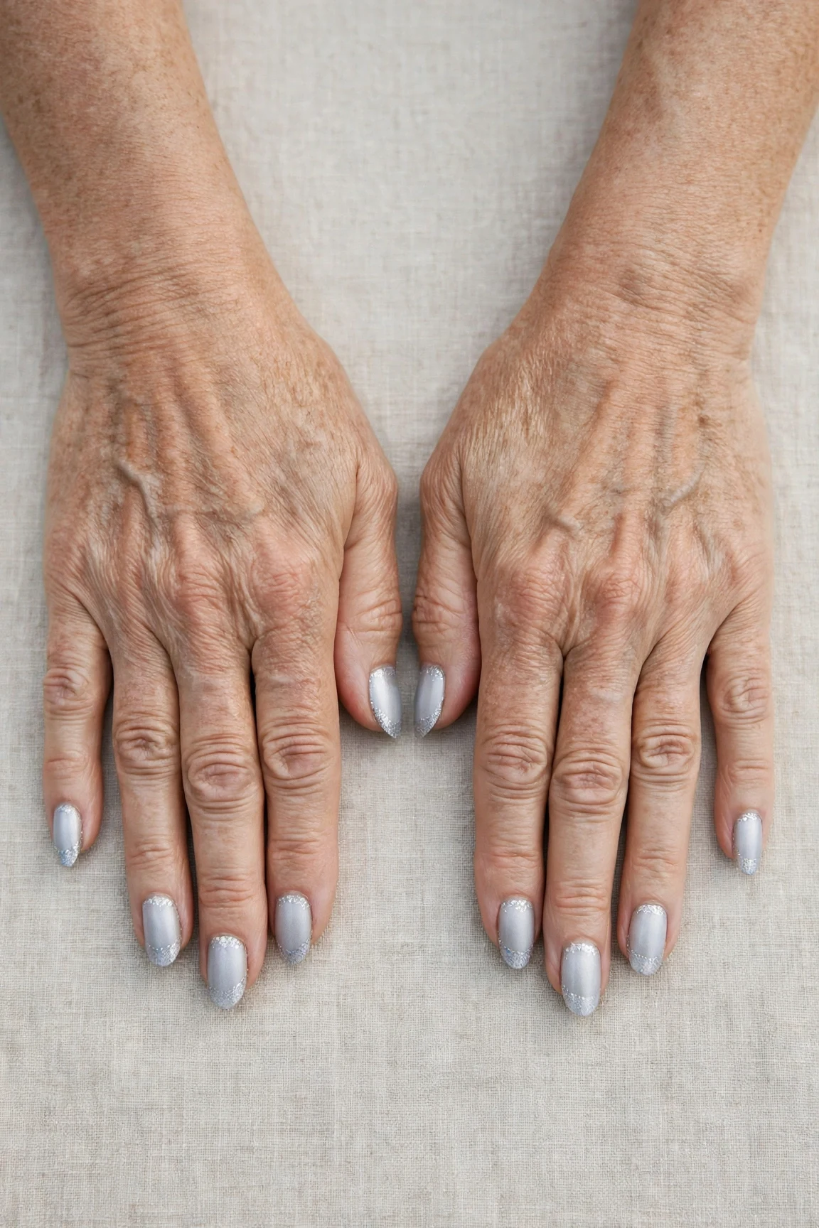 Almond Icy Silver Frosted Chrome Nails with a soft matte finish and silver shimmer tips