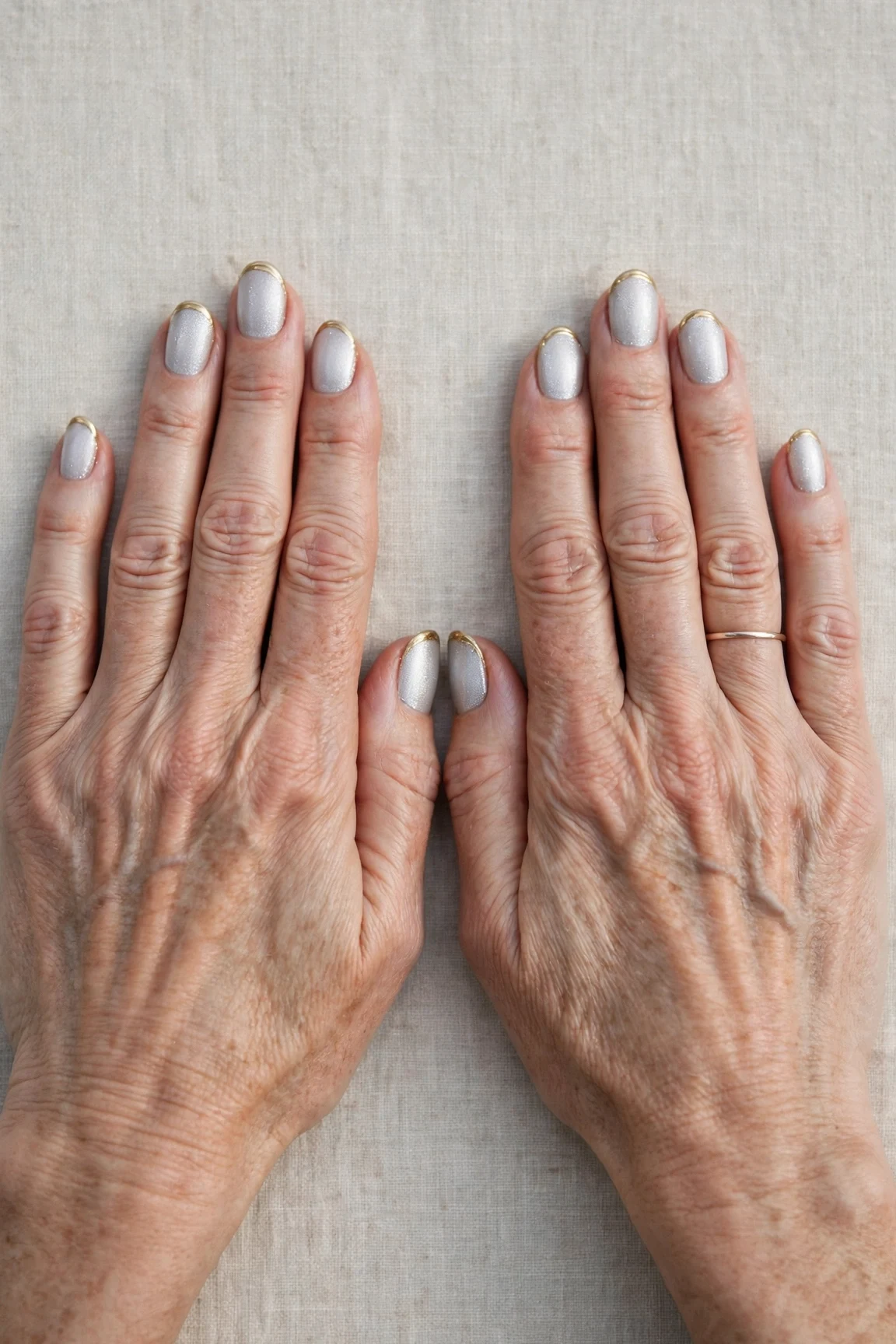 50 Icy Silver Frosted French Nails For Women Over 60 For New Year Celebrations That Are Chic, Warm and Elegant 21 Icy Silver Frosted French Nails with a pearl shimmer finish and gold French tips