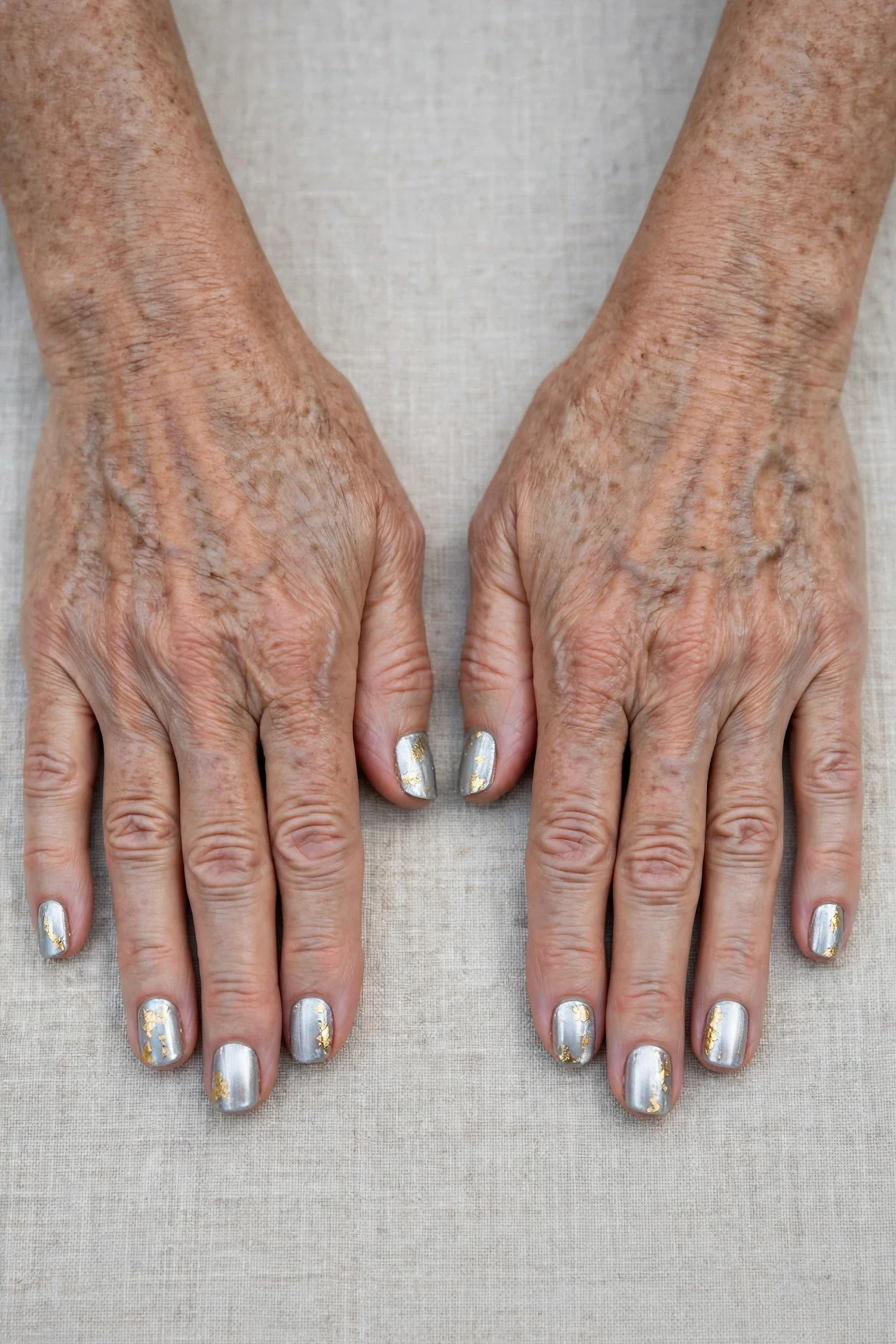 20 Icy Silver Frosted Nail Designs For Women Over 60 For Winter Weddings That Are Chic, Warm and Elegant 5 Short Square Icy Silver Frosted Nail Designs with a chrome shine and gold foil accents