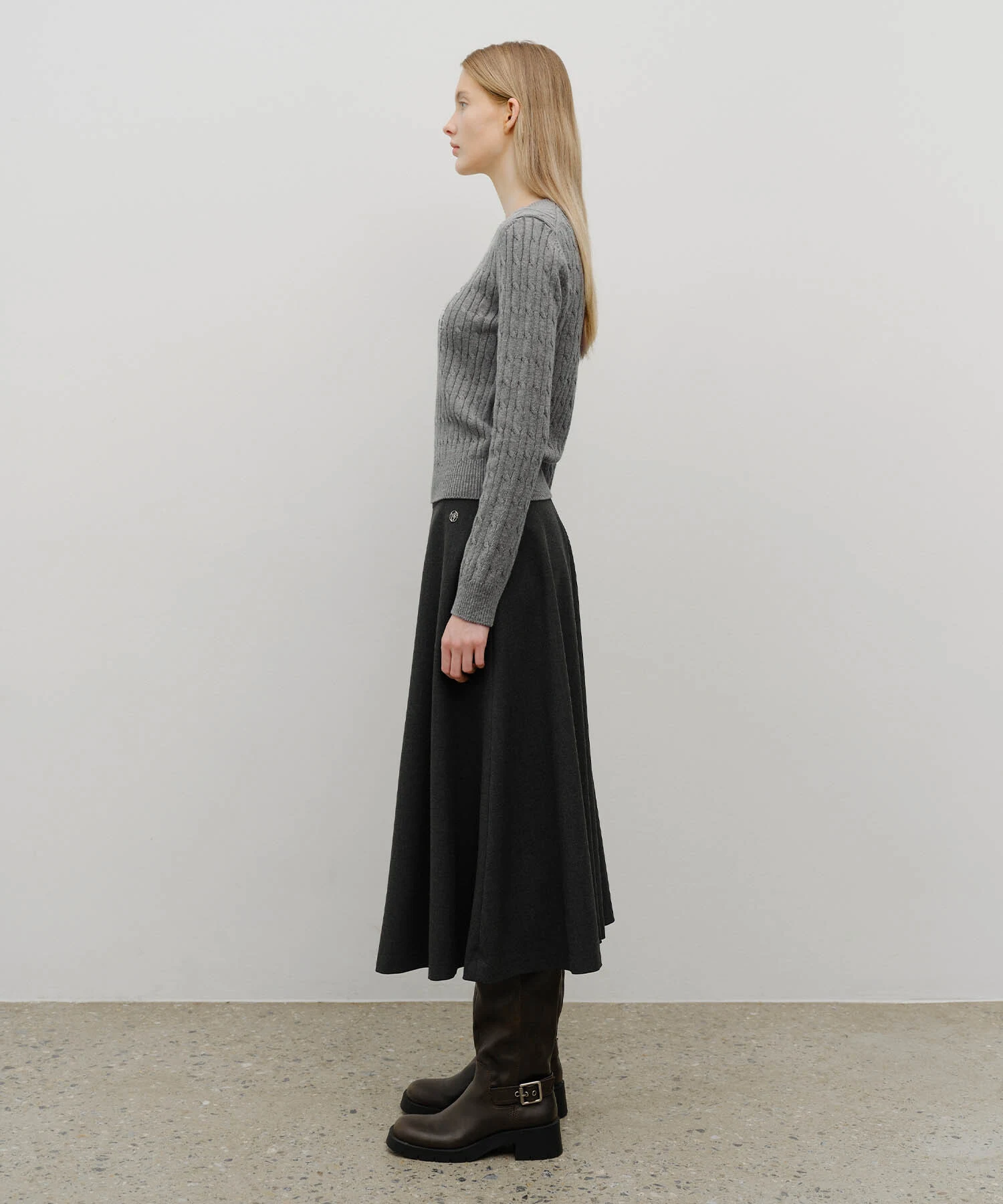 Grey Knit Sweater under a Navy Coat with Black Midi Skirt and Brown Ankle Boots