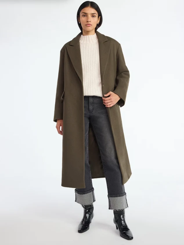 Cream Knit Sweater under a Olive Coat with Dark Jeans and Black Ankle Boots
