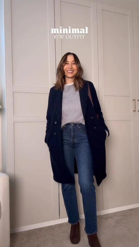 Grey Knit Sweater under a Navy Coat with Blue Jeans and Brown Ankle Boots