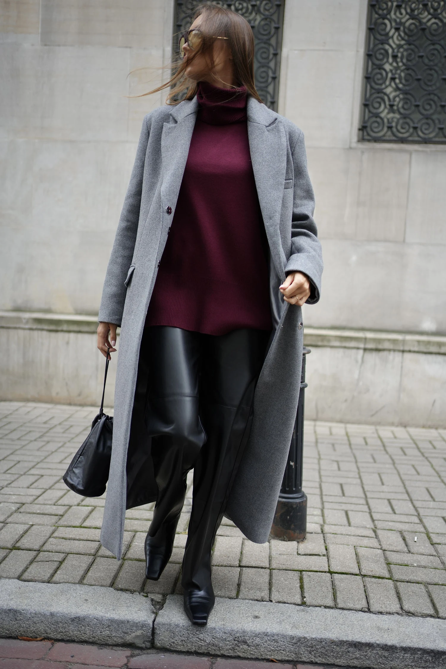Burgundy Knit Sweater under a Grey Wool Coat with Black Leather Trousers and Black Ankle Boots