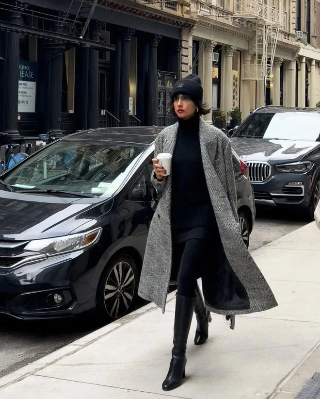 Grey Knit Sweater under a Grey Wool Coat with Black Trousers and Black Knee-high Boots