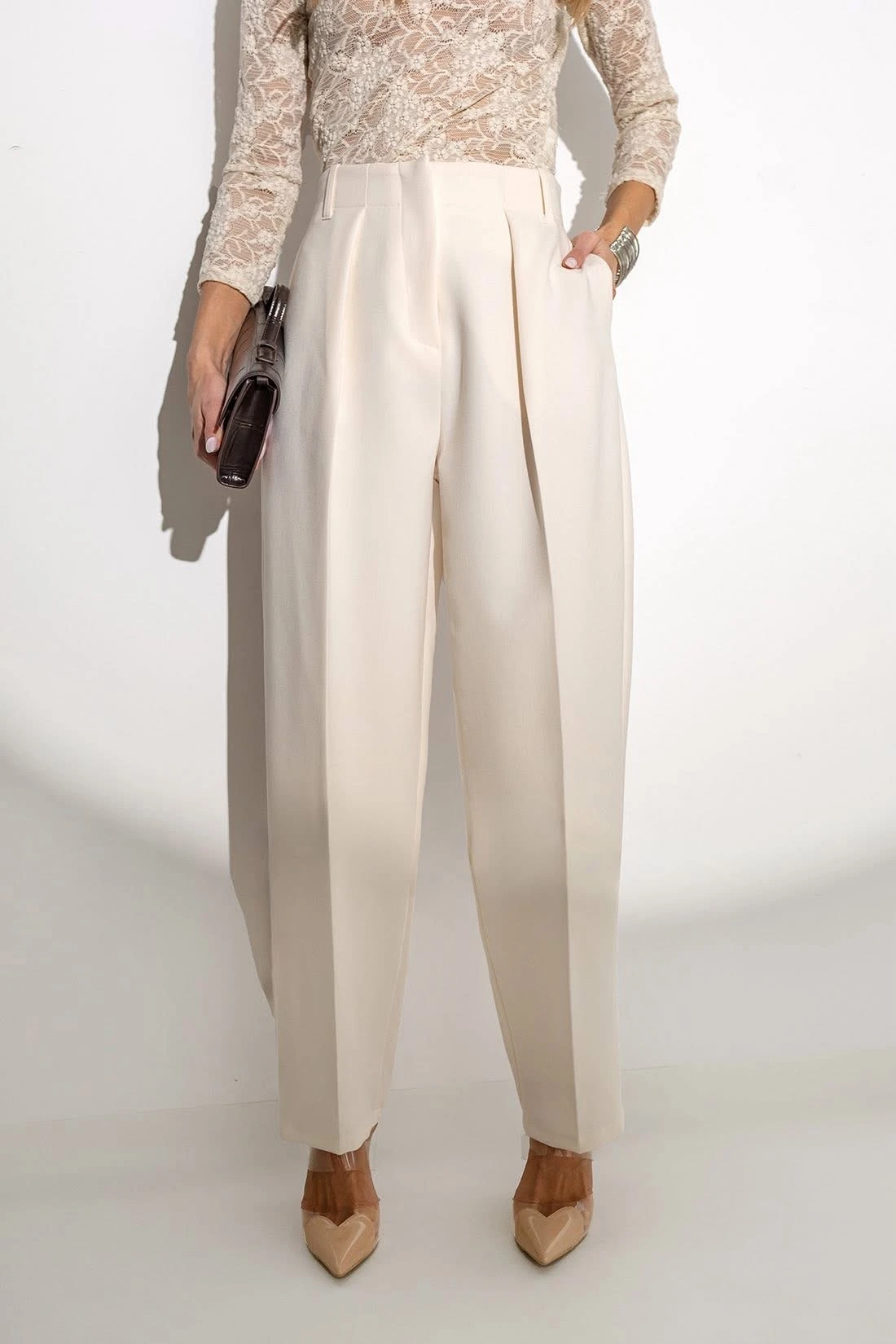 Ivory lace blouse and tailored trouser outfit with low-heeled pumps and a small structured clutch