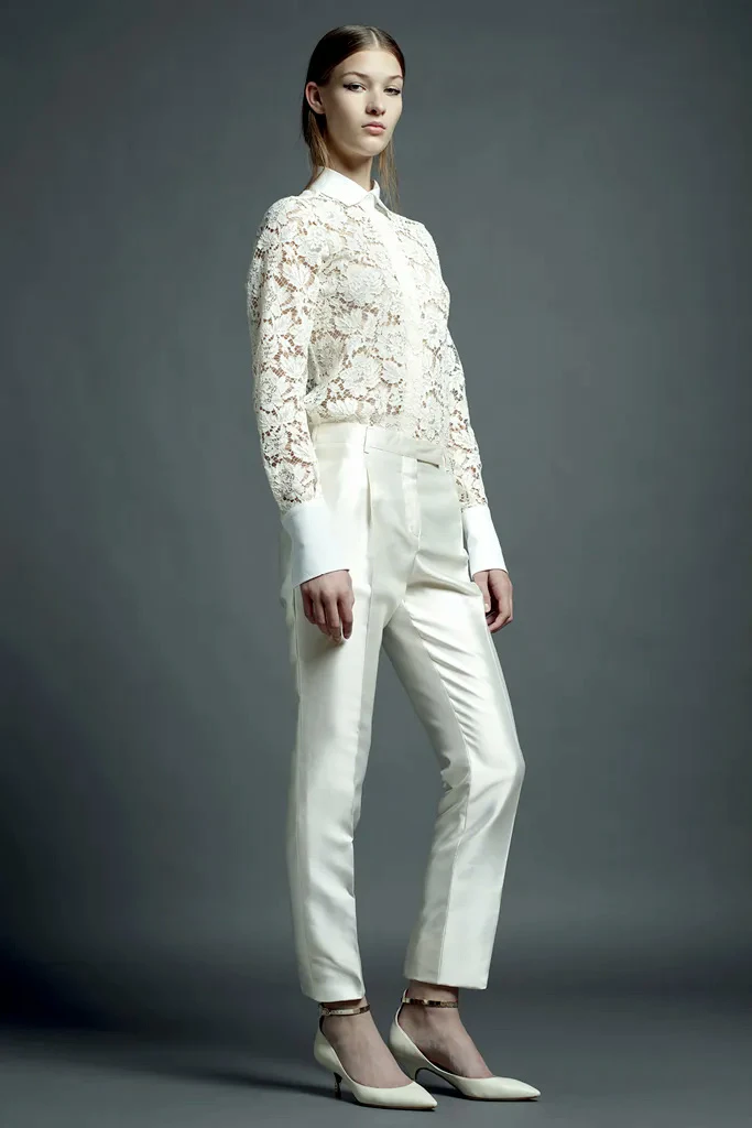 Cream lace top and satin trouser outfit with block-heel ankle boots and a pearl bracelet