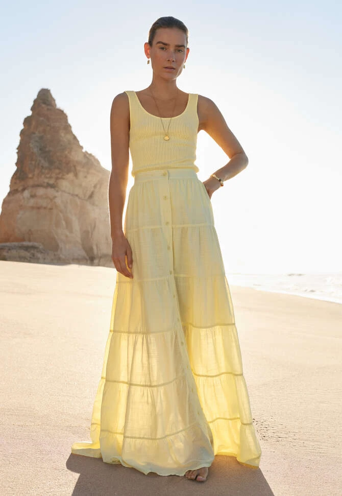 Pale Yellow Tiered Skirt with a delicate gold bracelet