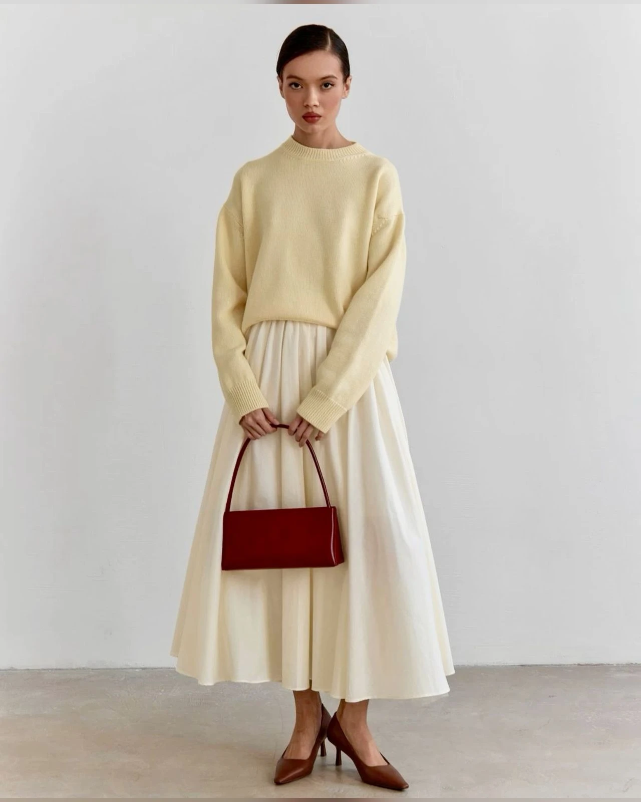 Butter Yellow Crew-Neck Sweater with a red clutch