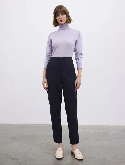 Lavender turtleneck sweater with navy straight trousers