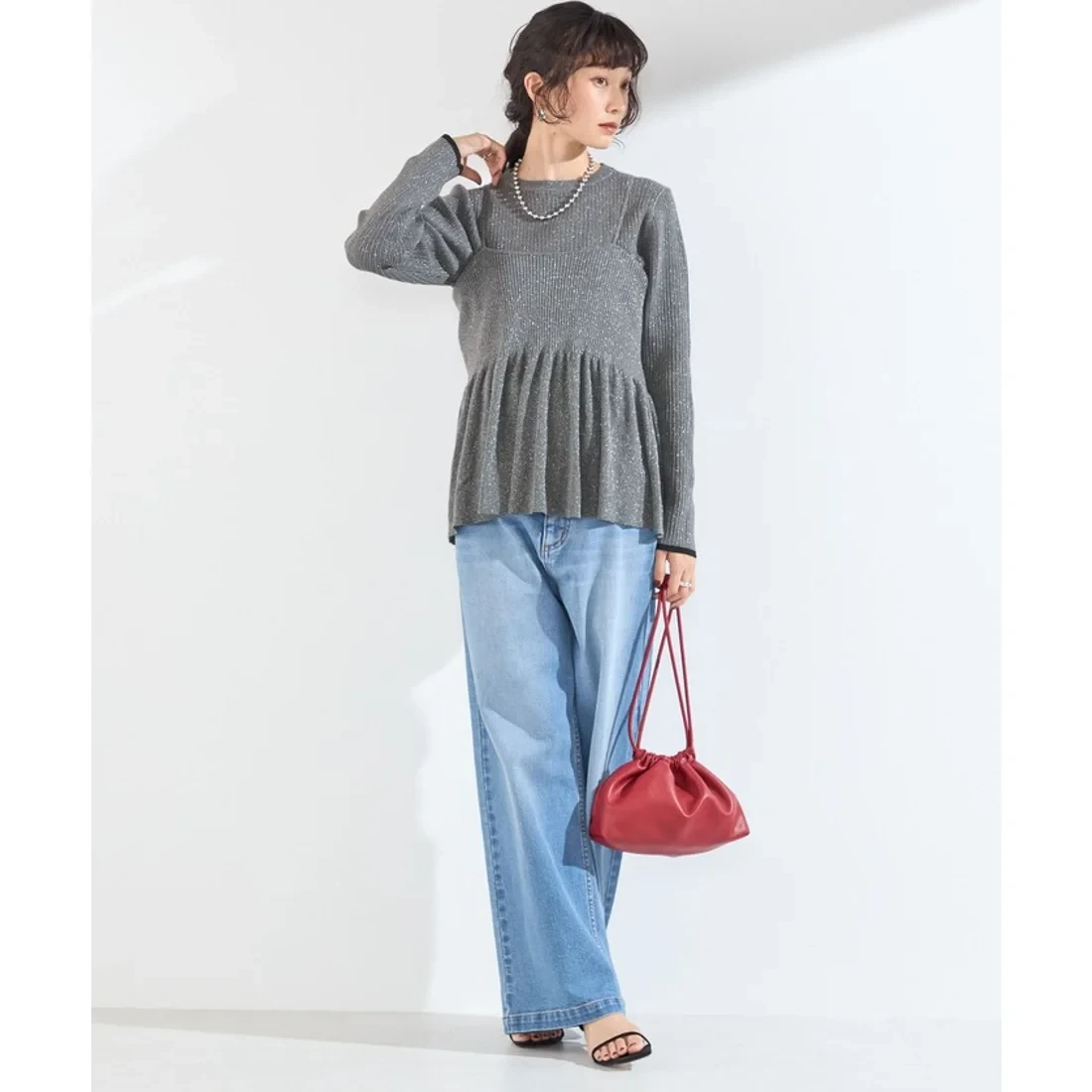 Grey Peplum Knit Top and Jeans with a red clutch