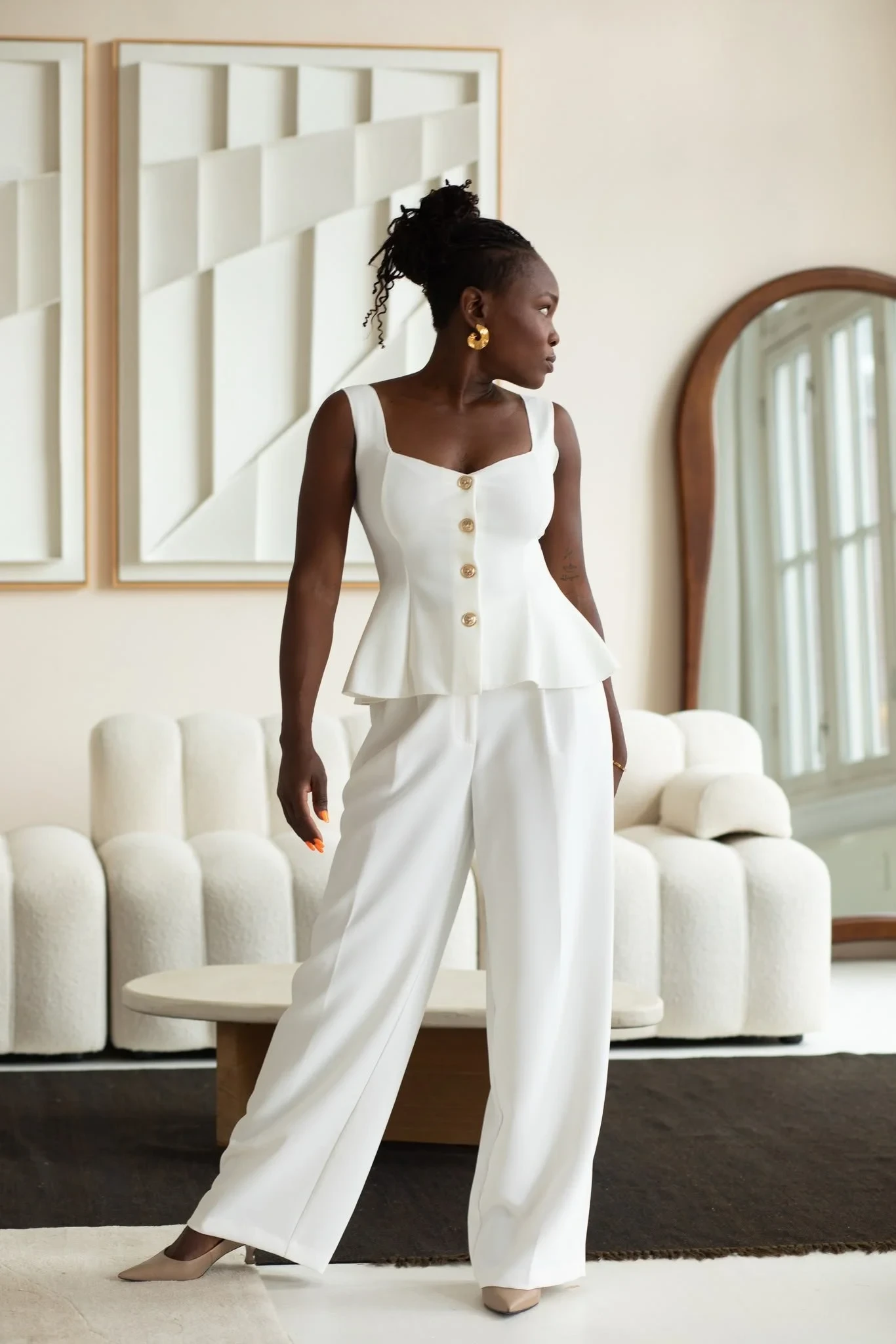 White Peplum Top and Wide-Leg Trousers with gold hoop earrings