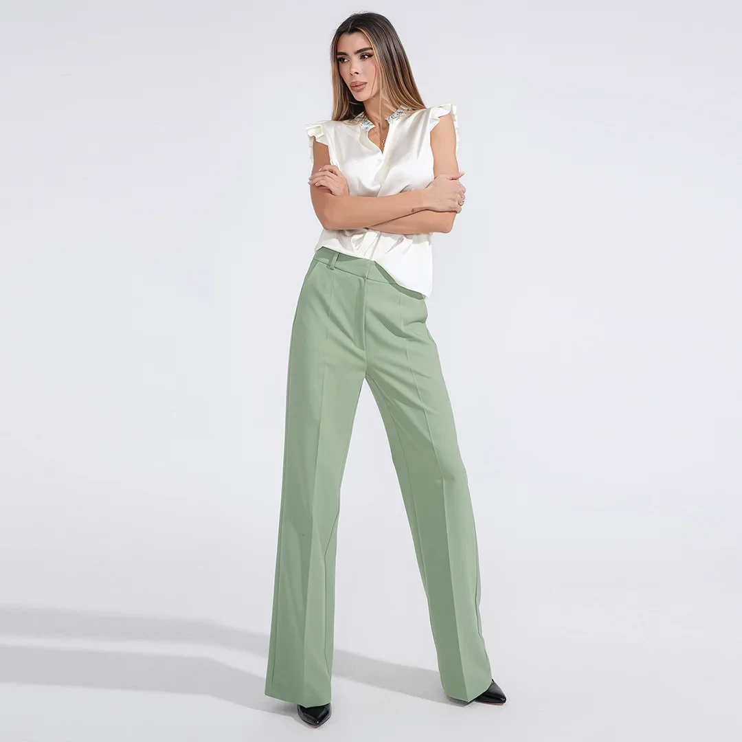 Sage green high-waisted trousers with a white silk blouse
