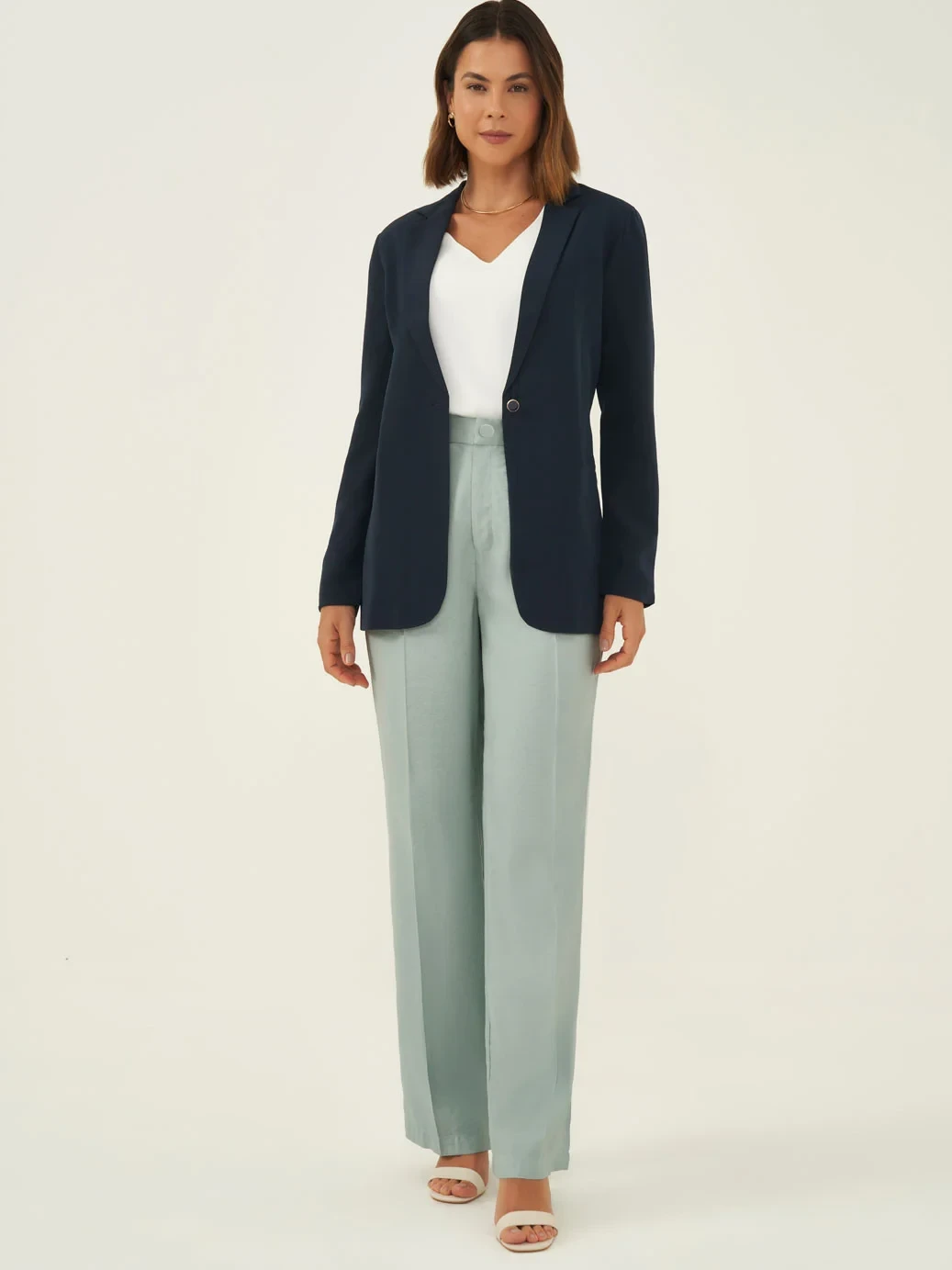 Sage green linen-blend trousers with a navy blazer