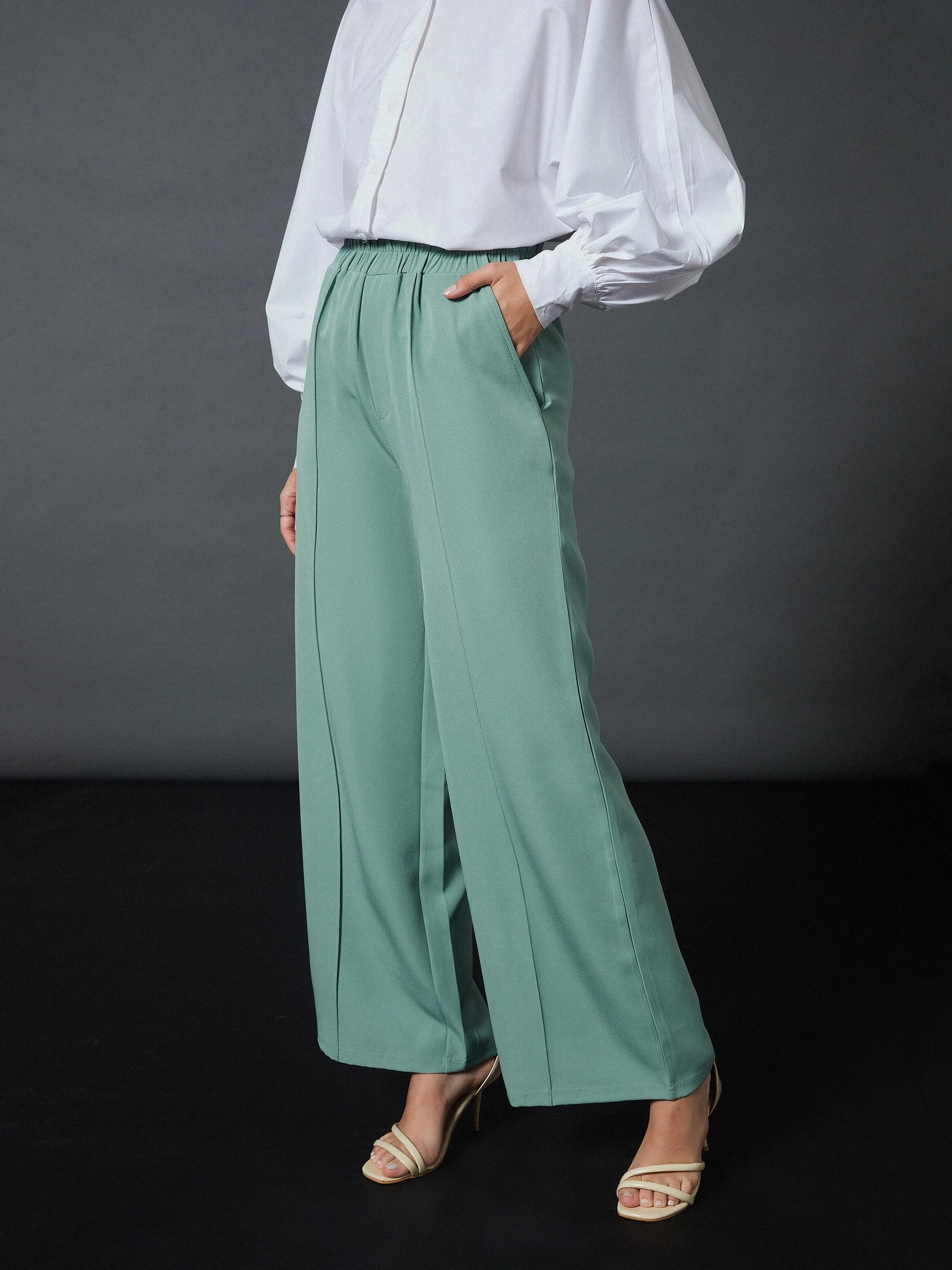 Sage green palazzo trousers with a white silk blouse