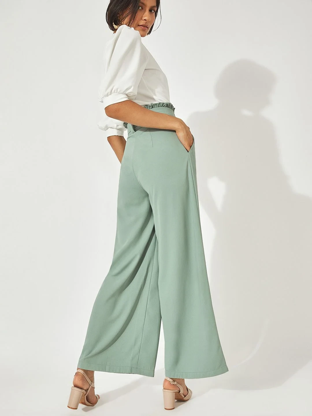 Sage green wide-leg trousers with a white peplum top