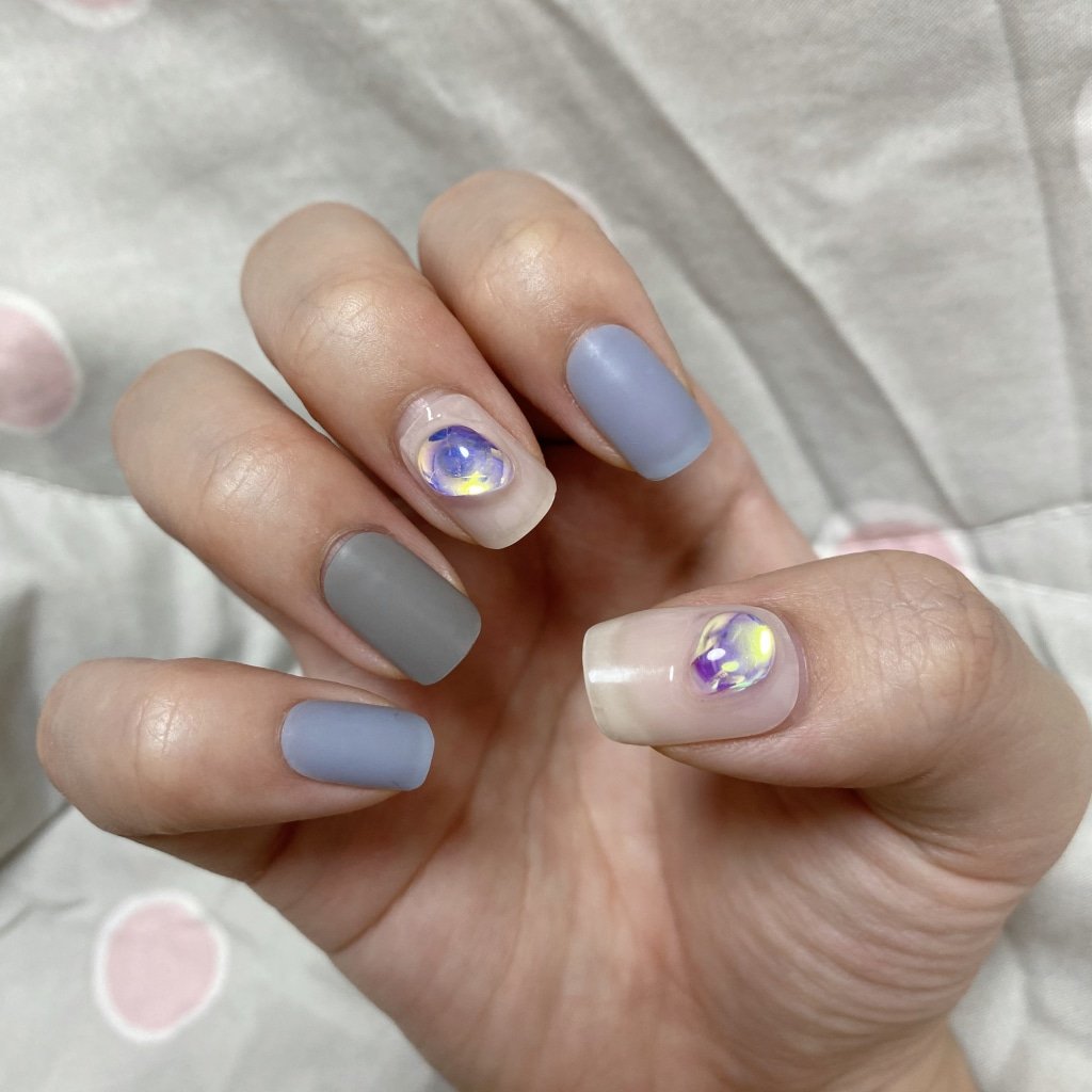 Matte Grey Oval Nails with Pastel Gem Accents for Late Winter