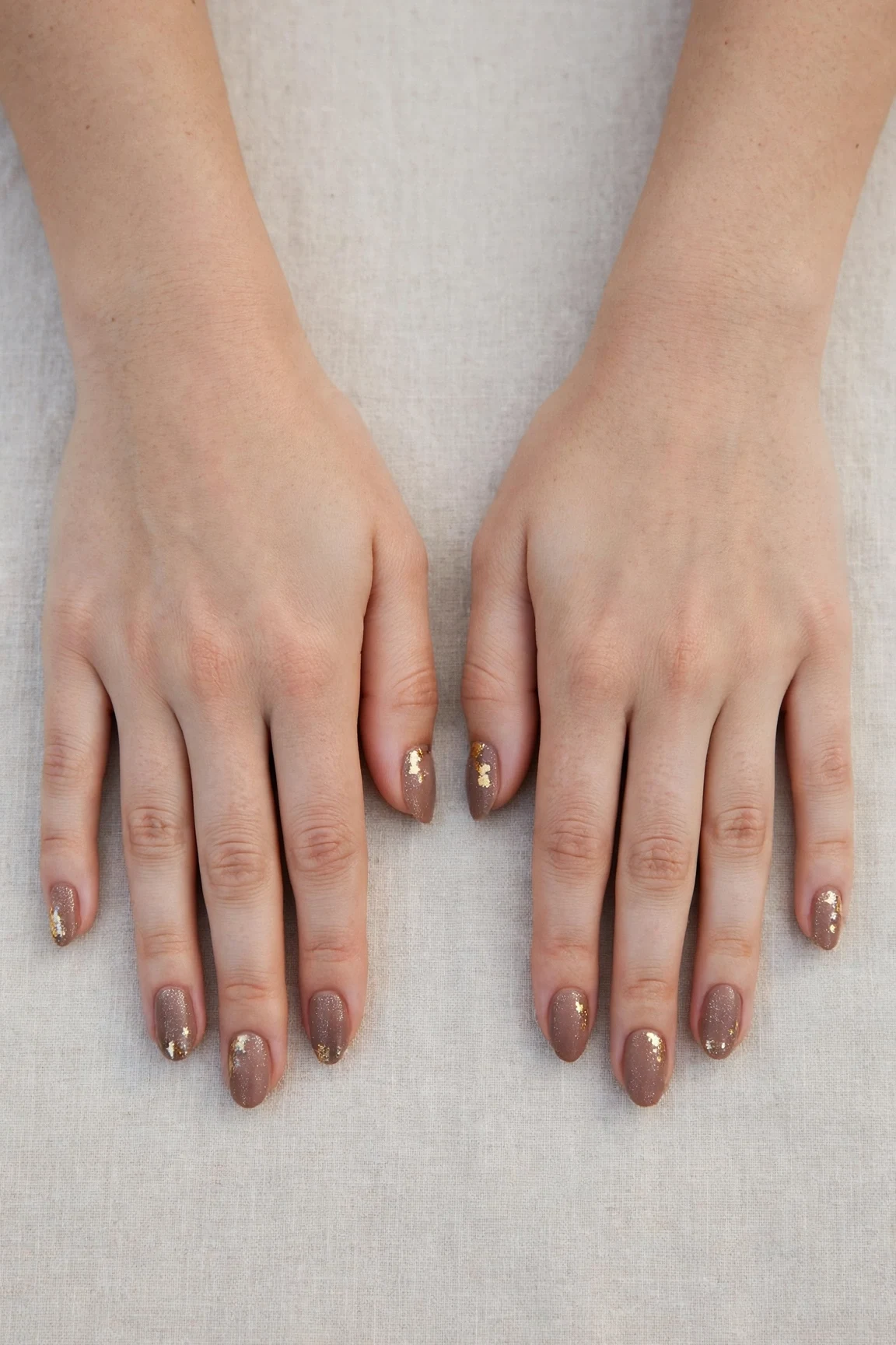 Oval Mocha Brown Glitter Christmas Nails with a velvet matte finish and gold foil accents
