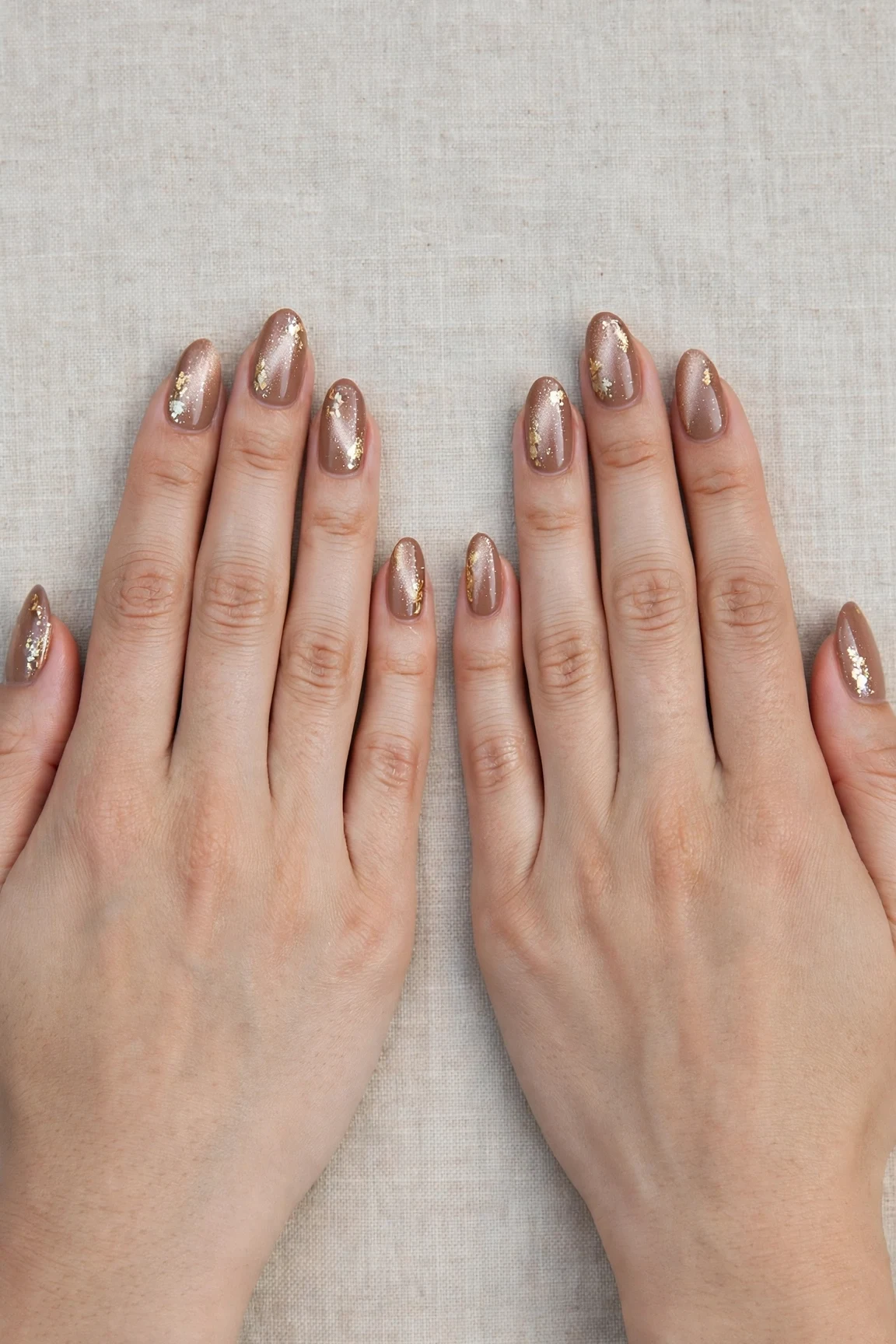 Almond Mocha Brown Glitter Christmas Nails with a pearl shimmer finish and gold foil accents