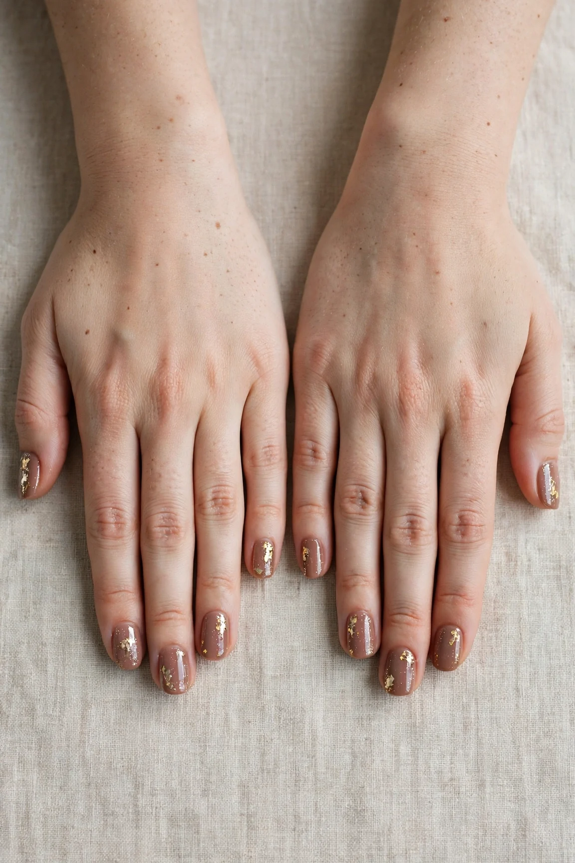 Short Square Mocha Brown Glitter Christmas Nails with a glassy gel finish and gold foil accents