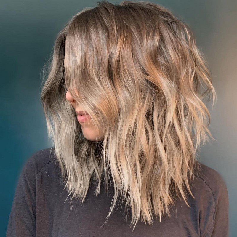 Natural Texture Spring Hairstyles For Wavy Hair With A Salt Spray Finish With Smooth Glossy Lengths, Feathered Ends And Delicate Blonde Dimension